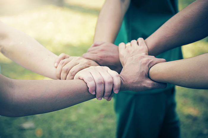 interlocking hands and arms