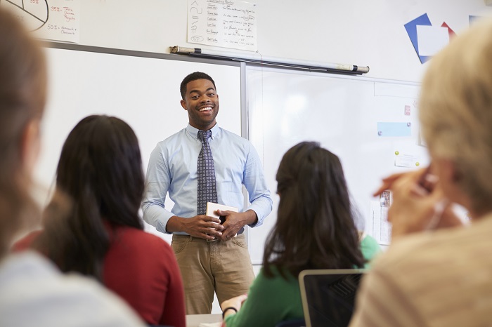 Teacher standing in front of a white board