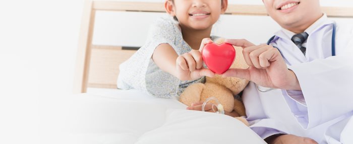 Adult and child holding an apple