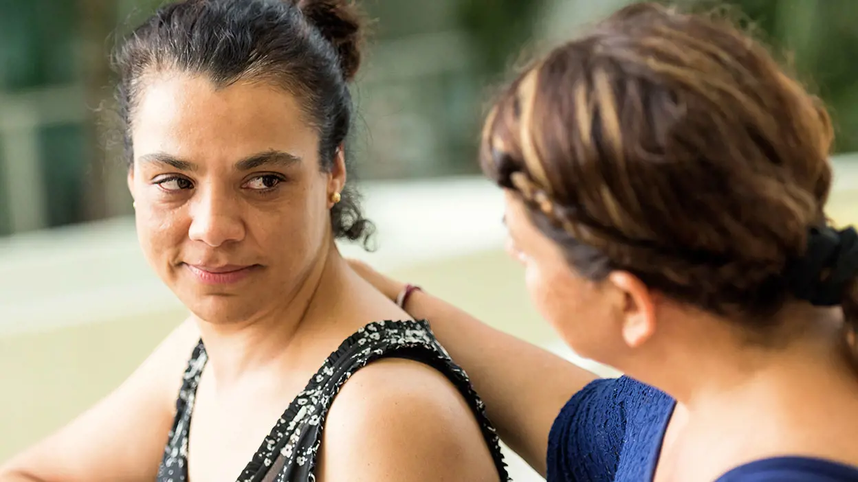 A woman offering another woman verbal intervention support 