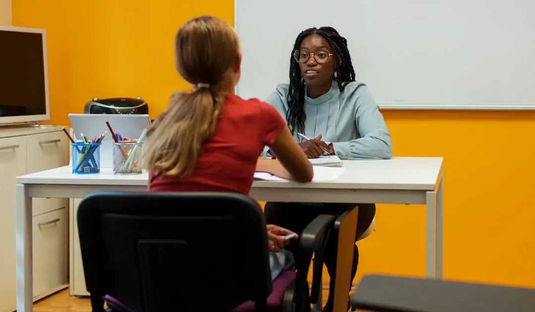 Female student talking to female teacher