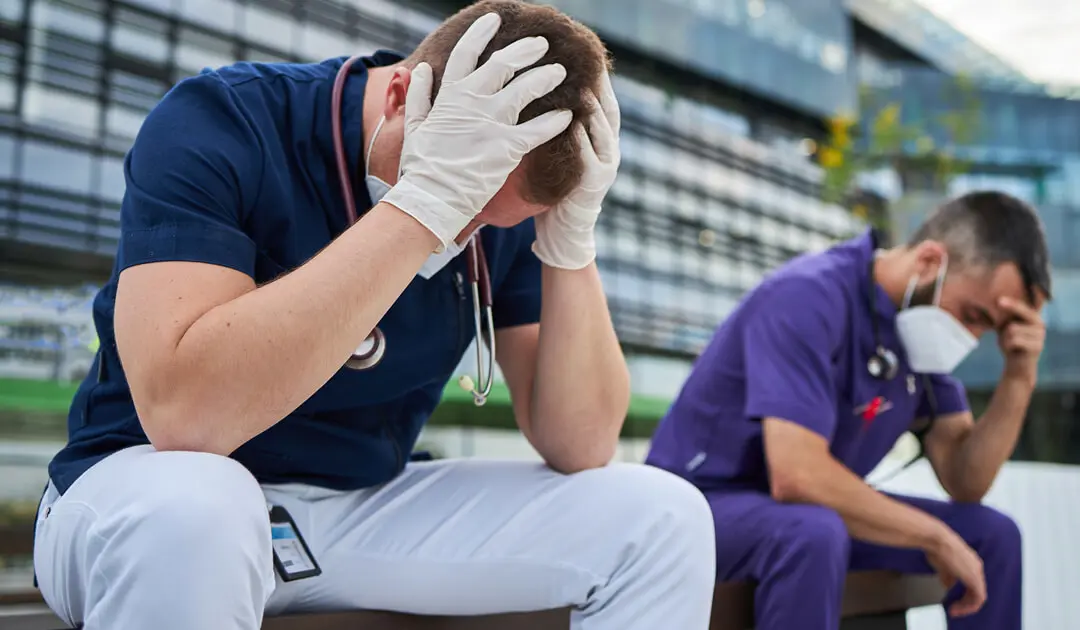 Frustrated man sitting next to nurse