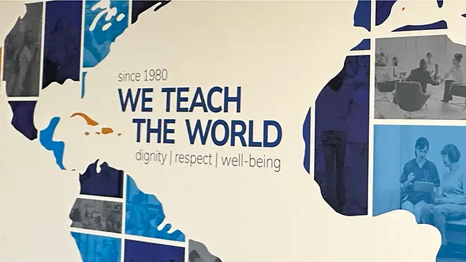 A wall graphic stating "since 1980, we teach the world dignity, respect, well-being."