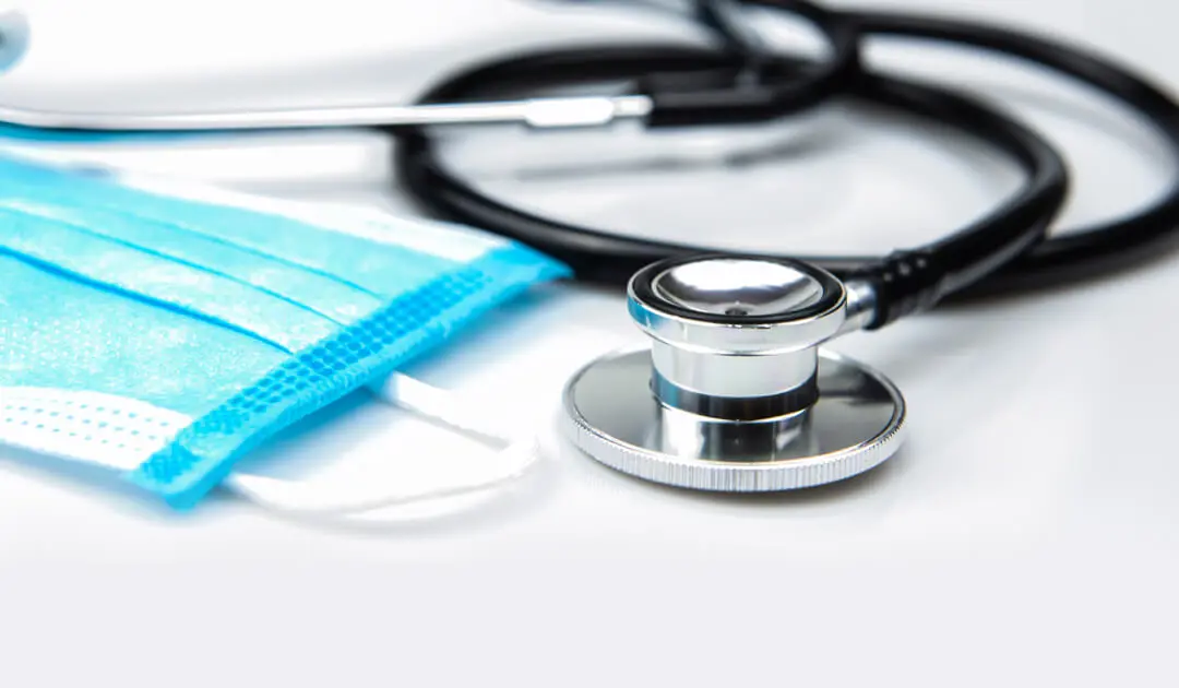A stethoscope and a mask laying flat.