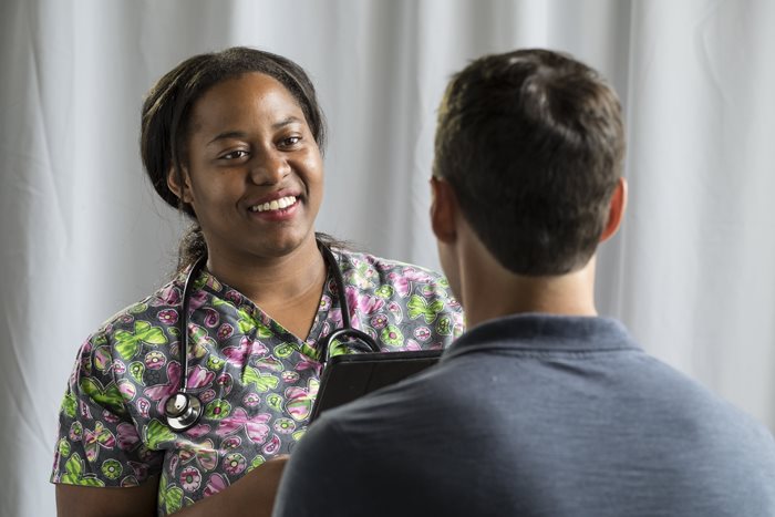 Nurse smiling at male patient