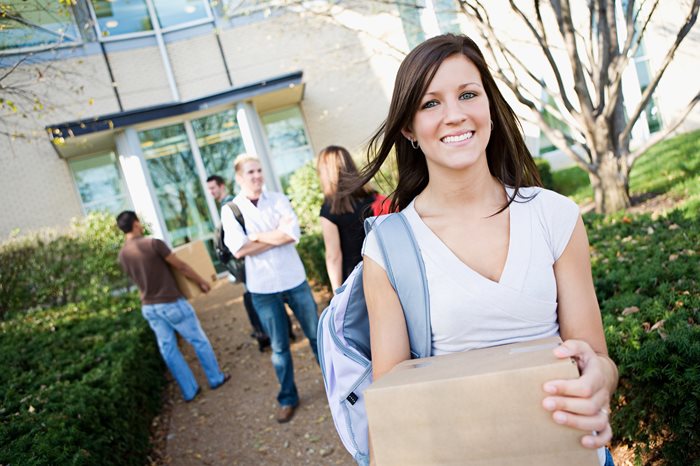 Female college student with box moving in